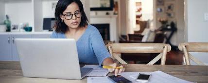 Student uses a calculator to review finances.